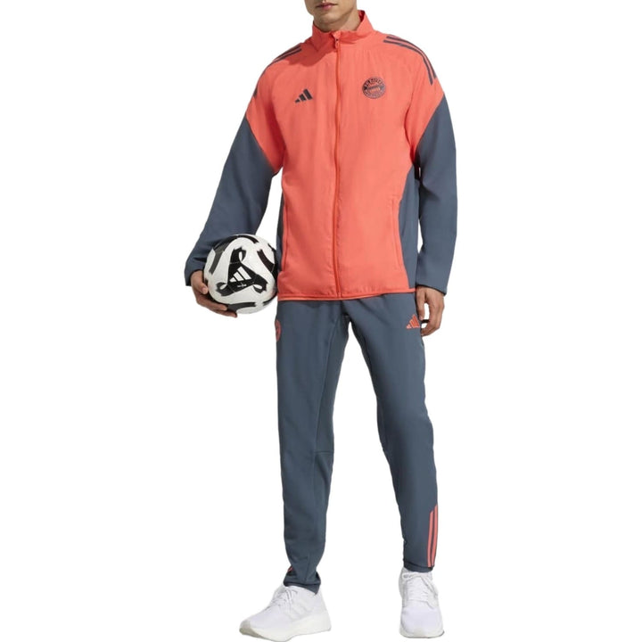 Bayern Munich presentation tracksuit 2025 in vibrant coral with sleek gray accents and soccer ball