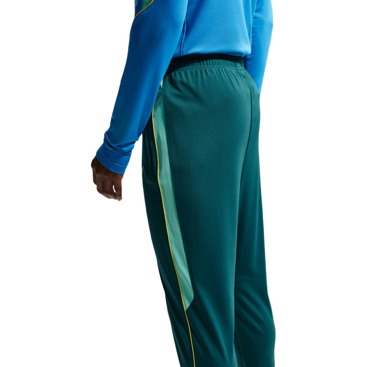 Men's green athletic pants in polyester with side stripe detail
