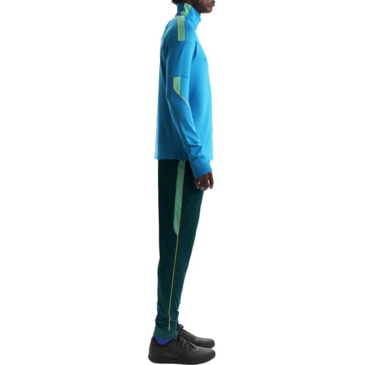 Blue athletic tracksuit with green accents, featuring a long-sleeve top and matching pants.