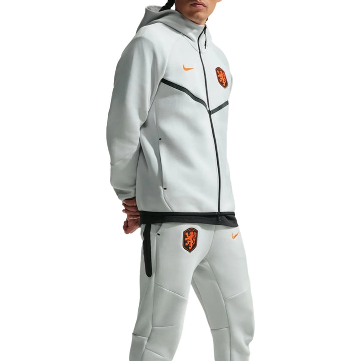 Nike Netherlands Tech Fleece presentation soccer tracksuit in light grey with orange accents for adults