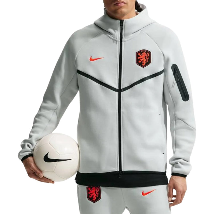 Nike Netherlands Tech Fleece 2026/27 presentation soccer tracksuit in grey with logo and contrasting details, set includes pants.
