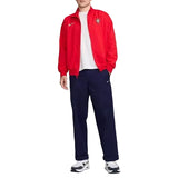 Person wearing a red Portugal jacket with Nike logo on a white background