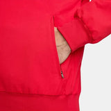Close-up of a red Nike x Portugal jacket with a zipper pocket on a white background