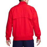 Person wearing a red Nike's Portugal soccer jacket on a white background