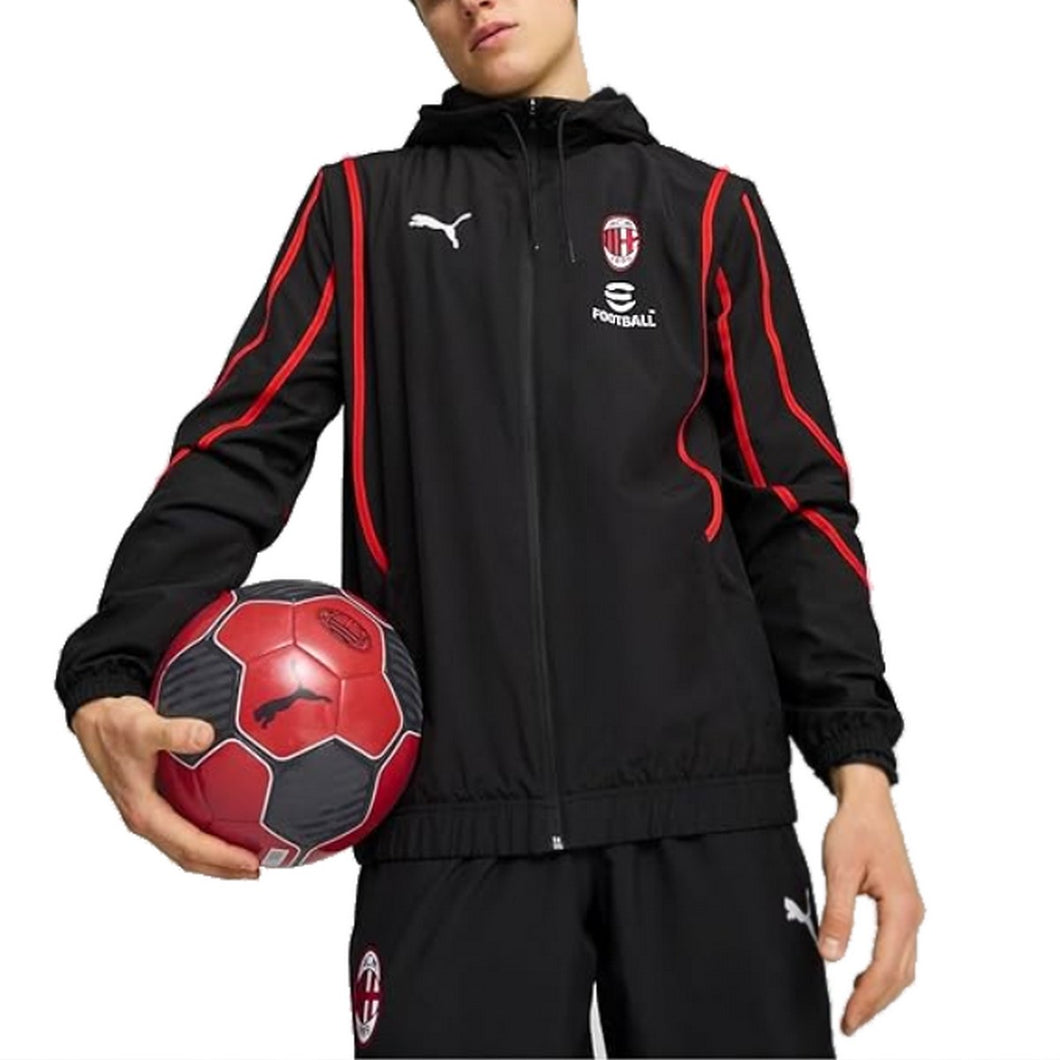 AC Milan pre game tracksuit 2024 in black with red accents, worn by a model holding a soccer ball