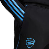 Close-up of black 2023 24 Arsenal football tracksuit set with blue stripes and Arsenal logo on pants