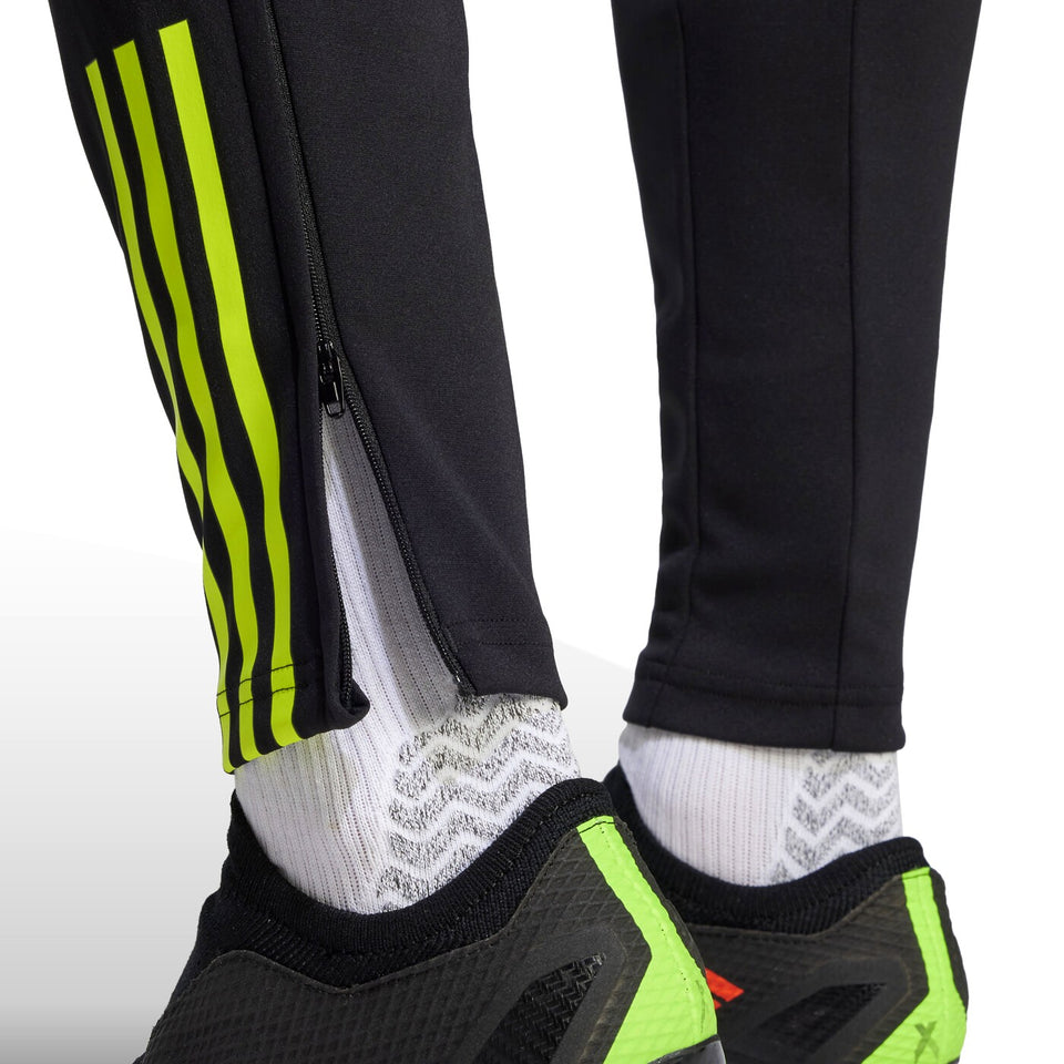 Close up of black pants with neon green stripes and zipper detail from 2023 24 Arsenal football tracksuit set