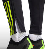 Close up of black pants with neon green stripes and zipper detail from 2023 24 Arsenal football tracksuit set