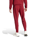 Back view of Adidas Belgium hooded tracksuit maroon pants worn with white sneakers