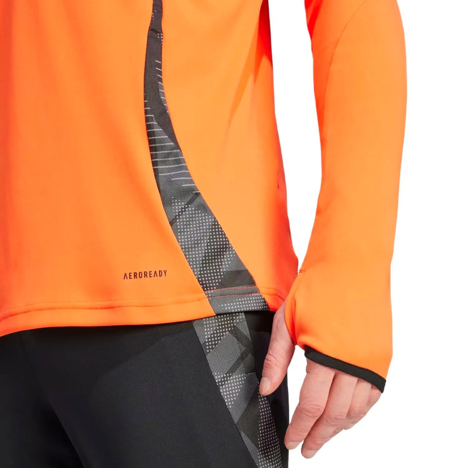 Close-up of Adidas Colombia training suit top in bright orange 