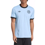 Light blue retro goalkeeper jersey with black trim and chest crest worn by model Germany 175th anniversary goalkeeper jersey