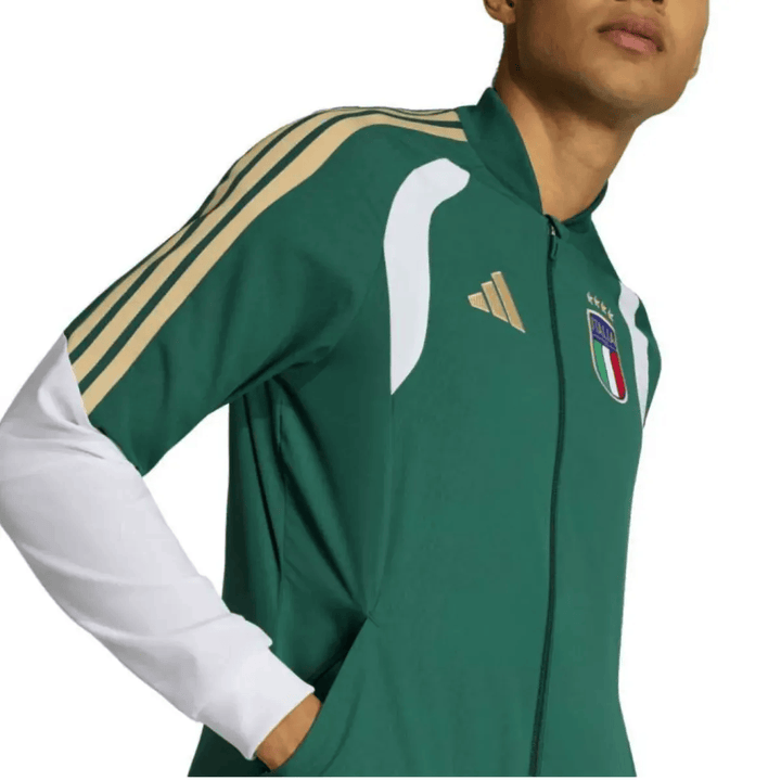 Italy green soccer tracksuit set by Adidas with gold accents and official logo for training and presentation.