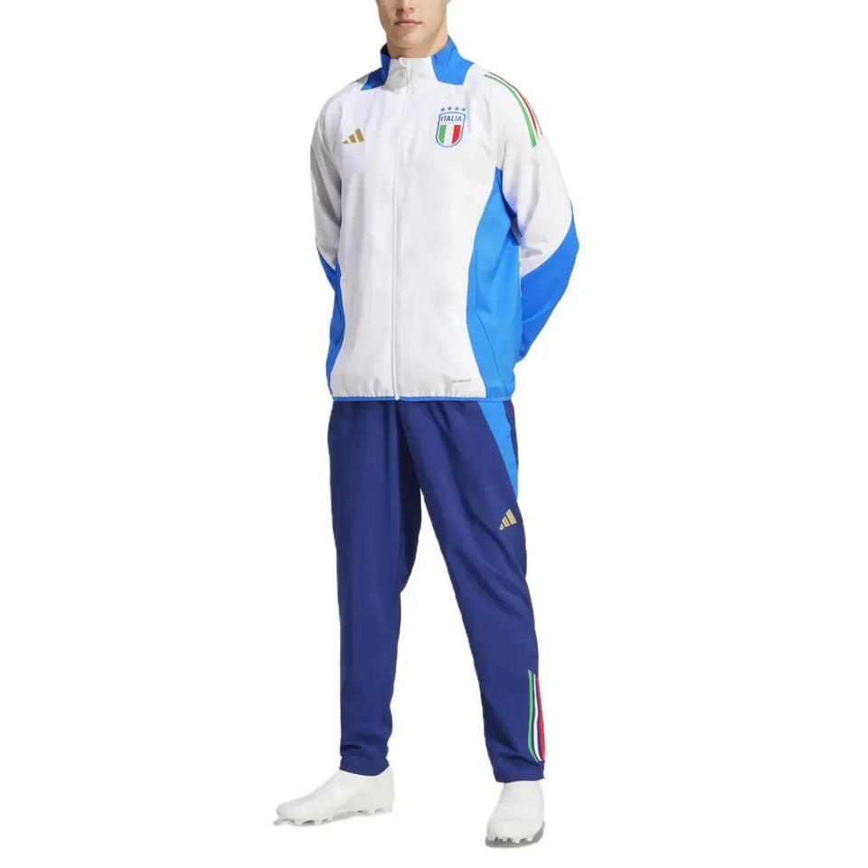 Italy national team presentation tracksuit white and blue zip jacket with crest and navy track pants on male model