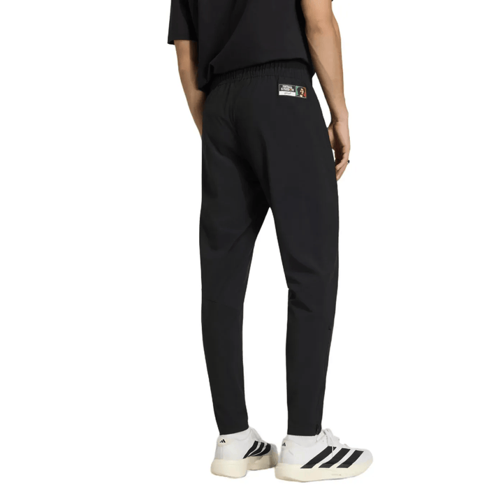 Black athletic joggers with elastic waistband and logo patch