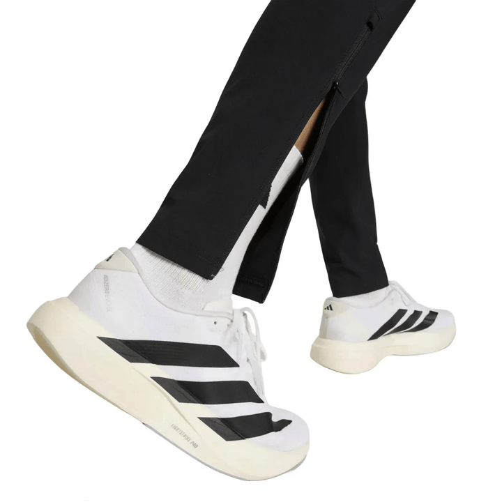 White Adidas running shoes with black stripes and cushioned sole