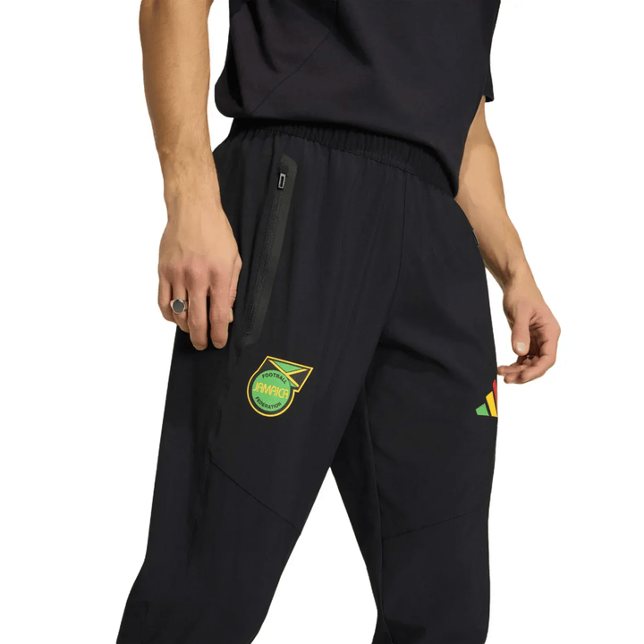 Black athletic pants with pockets and embroidered logo, featuring a tapered fit and elastic waistband.