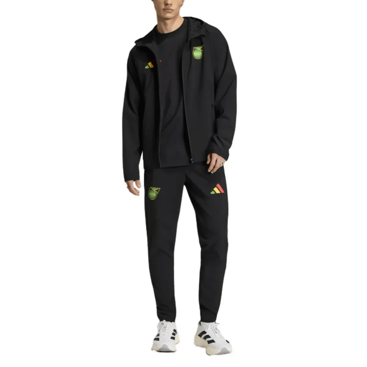 Black Adidas tracksuit with zip-up jacket and pants featuring logo details in green and red