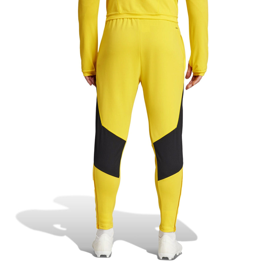 Back view of Juventus yellow training tracksuit 2024 pants with black panels and white shoes