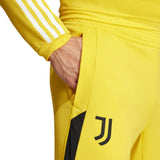 Close-up of Juventus yellow training tracksuit 2024 pants pocket with black logo and white stripes on sleeve