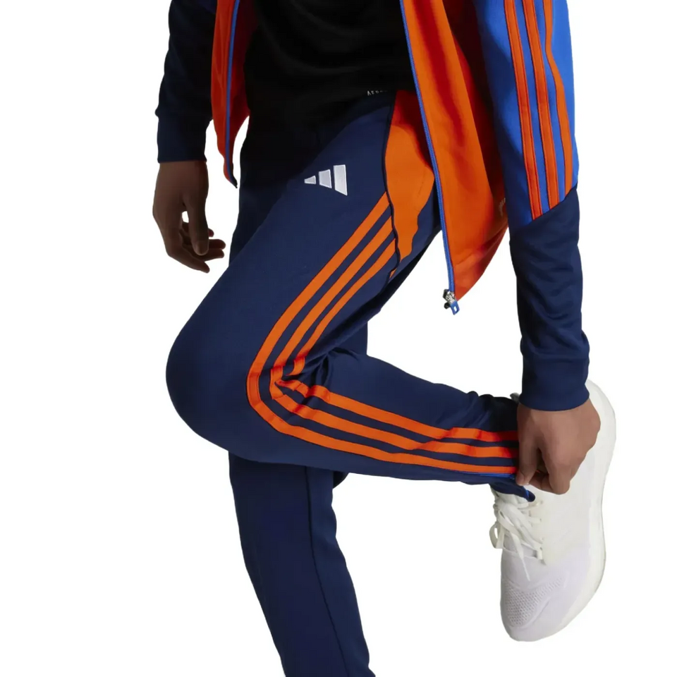 Kids Juventus tracksuit 2024 with navy blue and orange color blocking and white sneakers