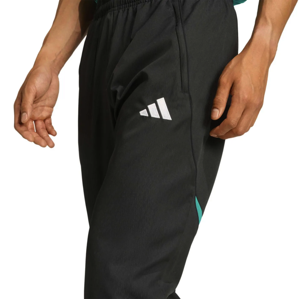 Liverpool Champions League tracksuit featuring sleek black design and stylish Adidas logo