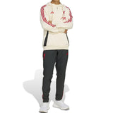 Liverpool FC hooded training tracksuit with cream hoodie and black pants featuring red accents and logos