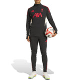 Adidas Liverpool training tracksuit 2025 in black with red accents worn by model holding a soccer ball