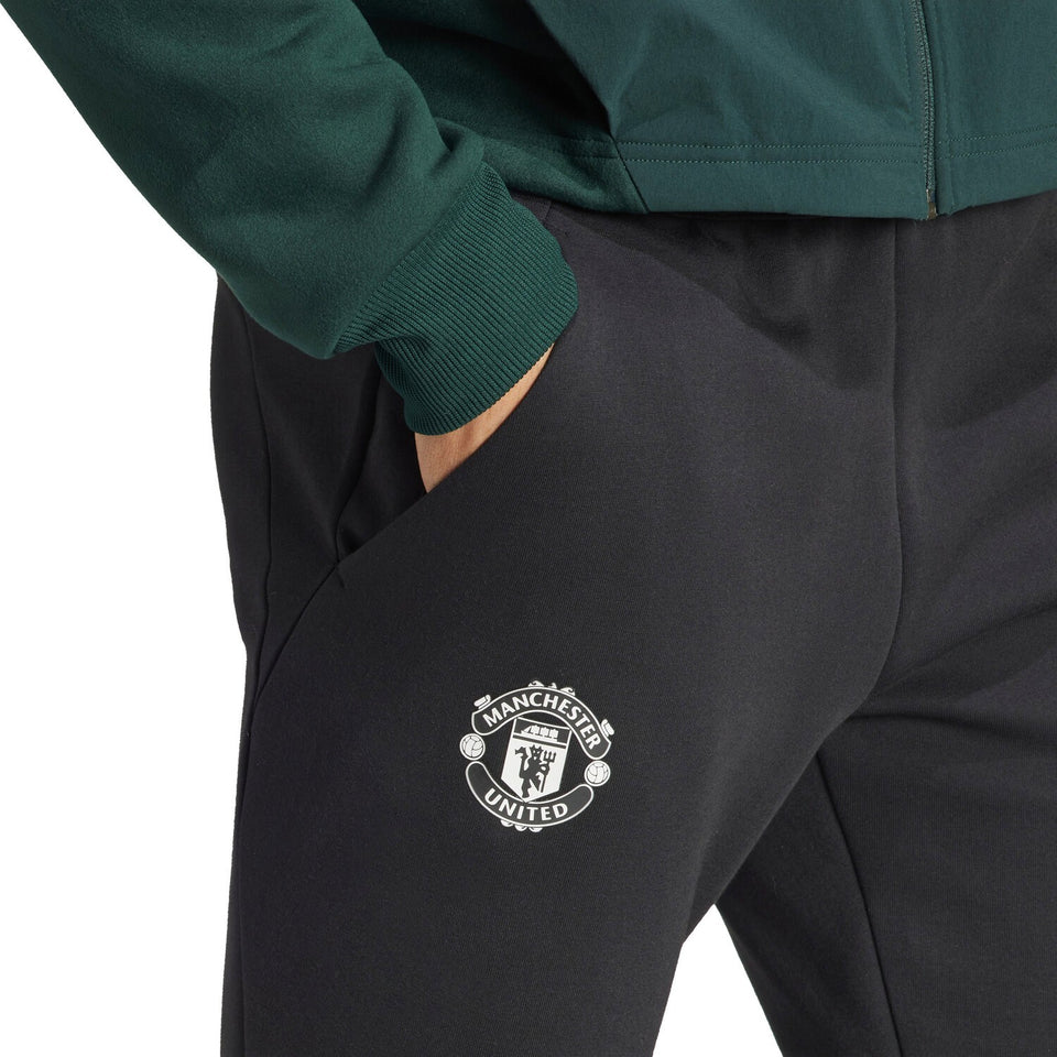 Adidas Man United pre-match suit featuring classic Manchester United logo and stylish design