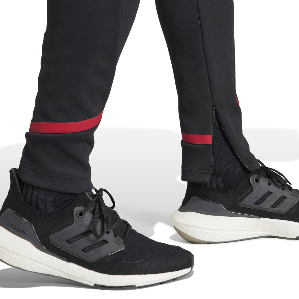 Adidas Man United pre-match suit featuring tapered pants and sleek design for soccer fans