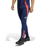 Blue and red Adidas pants from the Manchester United 2024 training tracksuit with black athletic shoes