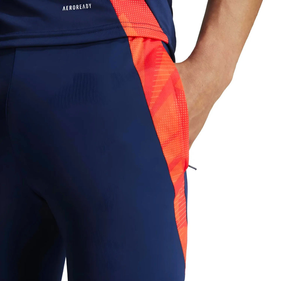 Close-up of navy and red Manchester United 2024 training tracksuit pants with Aeroready fabric