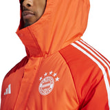 Close-up of official Bayern Munich Adidas parka in red with white stripes and club logo on chest