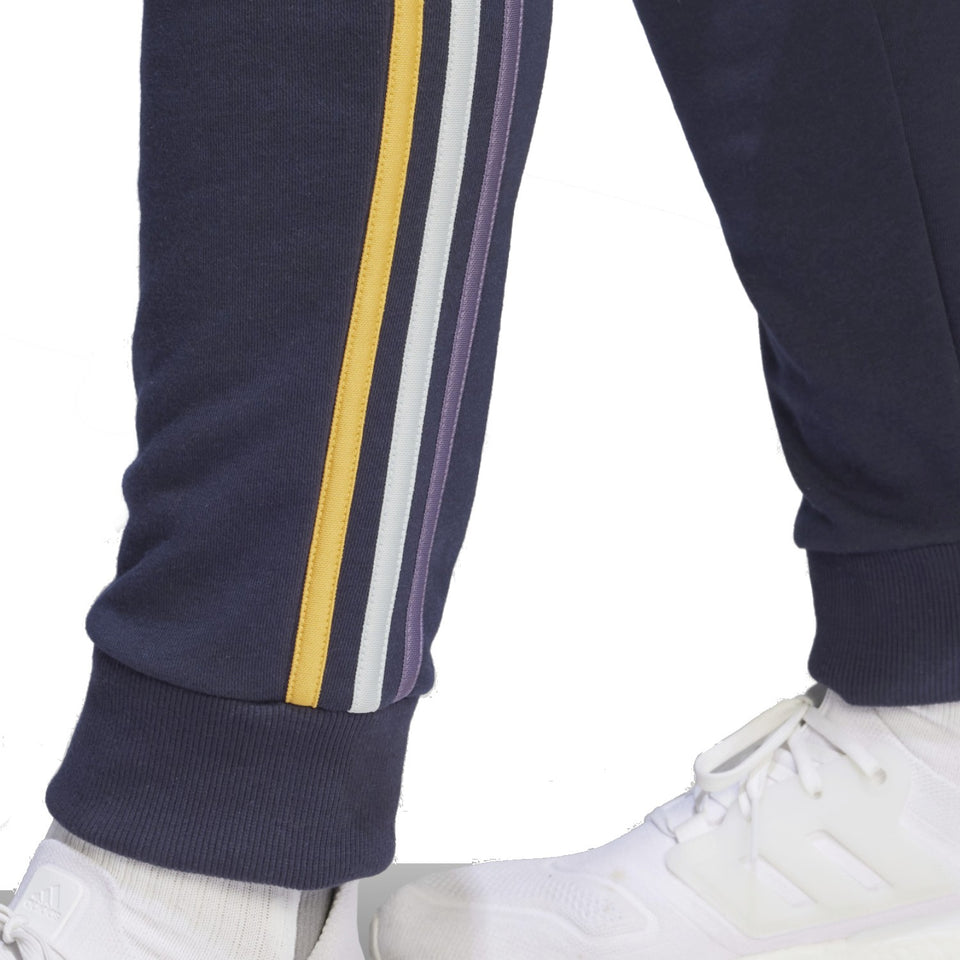 Detail of Adidas Real Madrid hooded soccer tracksuit highlighting stylish stripes on the pants