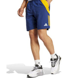 Real Madrid training kit 2024 navy and yellow shorts with Adidas logo worn with white sneakers