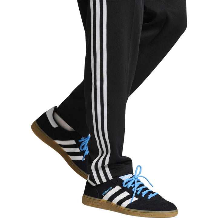 Black Adidas Gazelle running shoes with blue laces and gum rubber sole