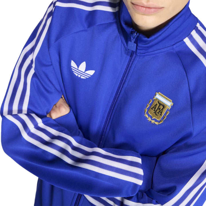 Blue Adidas track jacket with white stripes and embroidered logo