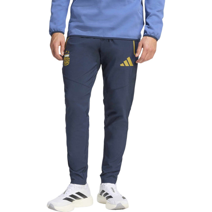Men's navy polyester training pants with gold logo by Adidas and tapered fit