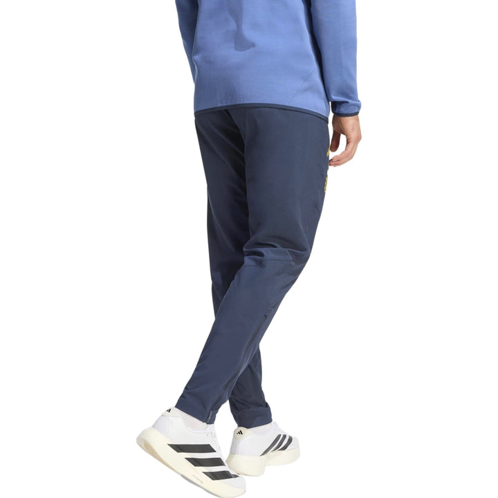 Men's navy athletic pants in polyester with zippered pockets and tapered fit