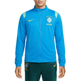 Person wearing a blue Nike x Brazil soccer tracksuit for FIFA World Cup 2026 on a white background