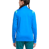 Girl wearing a blue Nike x Brazil FIFA WC 2026 prsentation soccer tracksuit with green accents on a white background