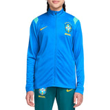 Girl wearing a Nike x Brazil blue and green presentation tracksuit with Nike logo on a white background