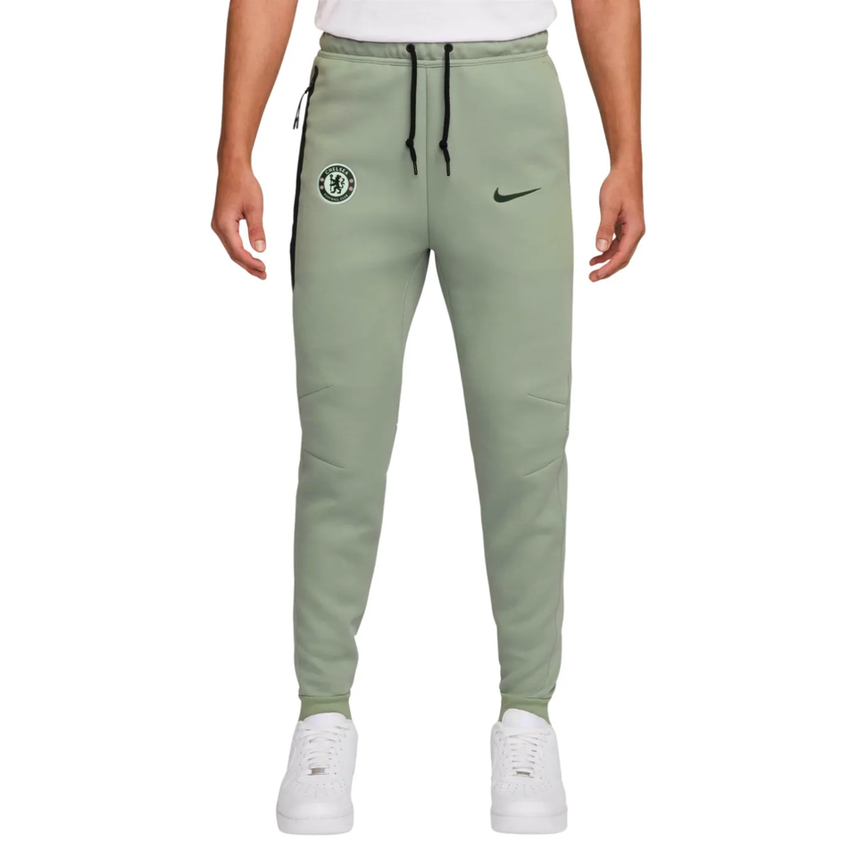 Official Chelsea Nike Tech fleece set featuring tapered joggers with team logo on SoccerTracksuits.com