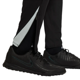 Close-up of black soccer training pants with zipper detailing, featuring the Chelsea Total 90 training tracksuit 2025