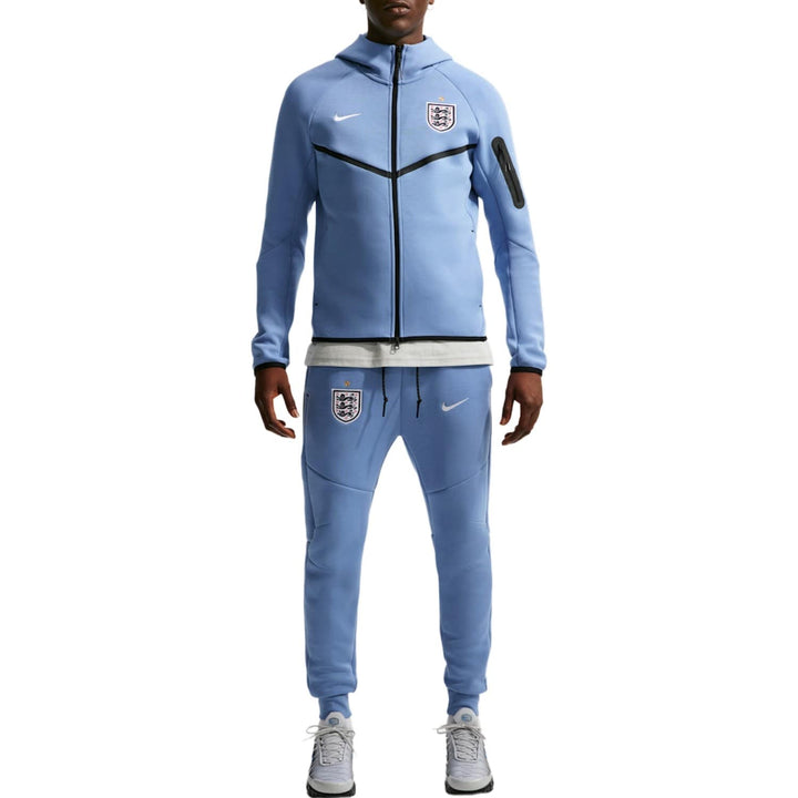 Light blue Nike tracksuit with zip-up jacket and matching pants, featuring England crest.