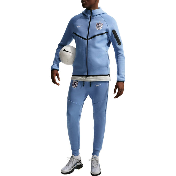 Light blue Nike tracksuit with zippered jacket and pants, featuring a logo on the chest.