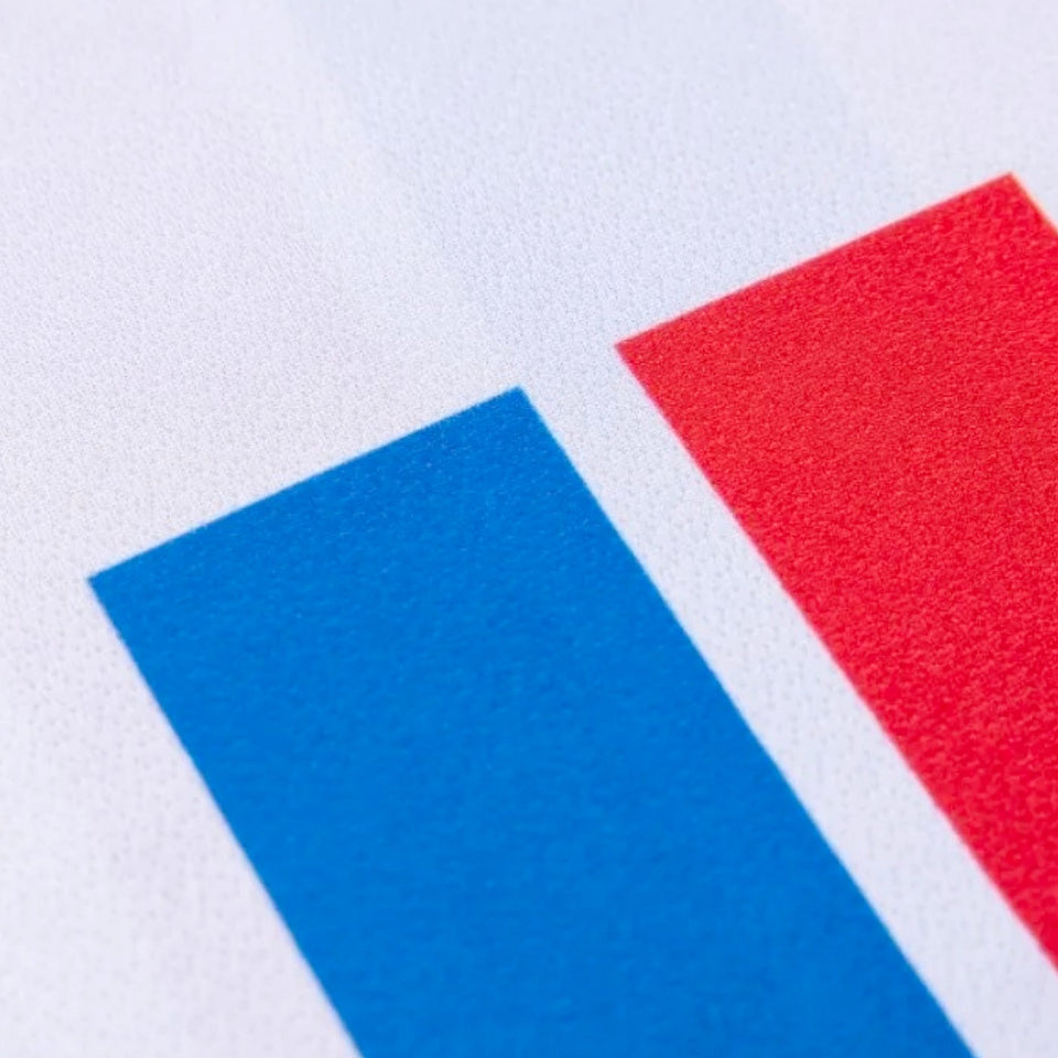 Close-up of Faroe Islands 2024 soccer jersey detail featuring blue and red stripes on white fabric