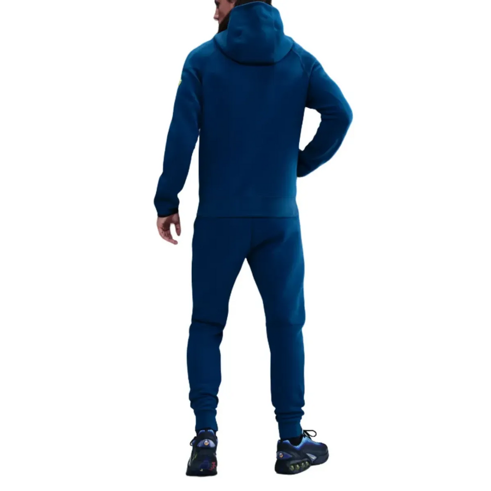 Model wearing FC Barcelona blue Tech Fleece tracksuit 2026 showcasing a sporty outdoor style