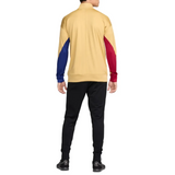 Back view of the FC Barcelona gold tracksuit 2024 featuring vibrant blue and red sleeves