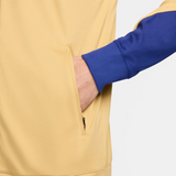 Close-up of the FC Barcelona gold tracksuit 2024 featuring a pocket and comfortable fit
