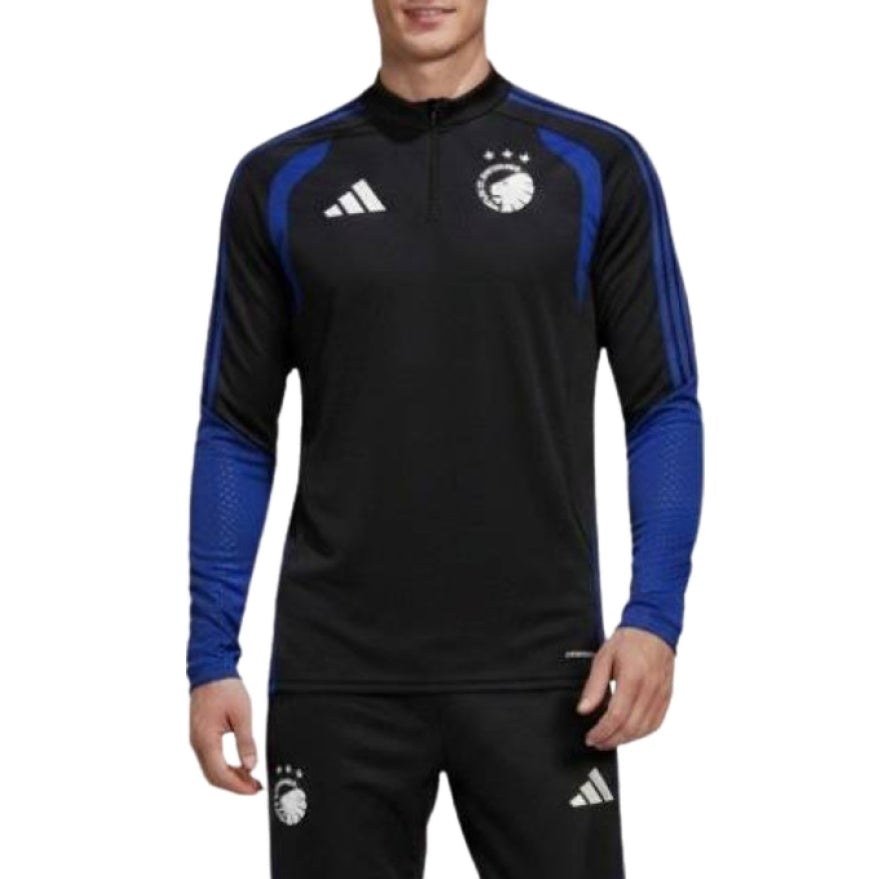 A man modeling a black and blue Adidas x FC Copenhagen training top and matching pants against a white background.